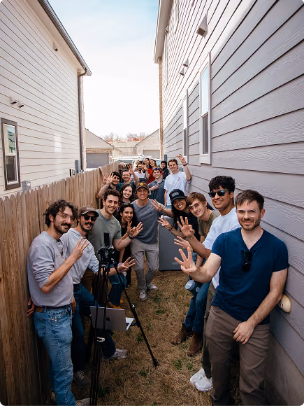 Base teammates gathered beside a home at an installation